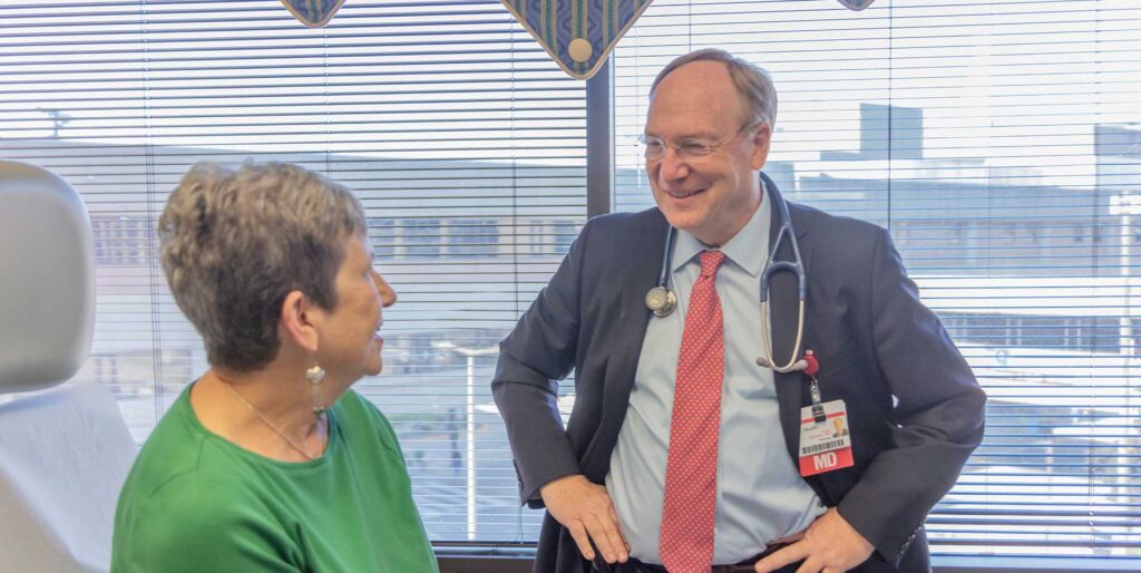 Dr. Goetz Kloecker with one of his patients. Thoracic oncology has grown in popularity as physicians embrace the enhanced opportunity for good outcomes.