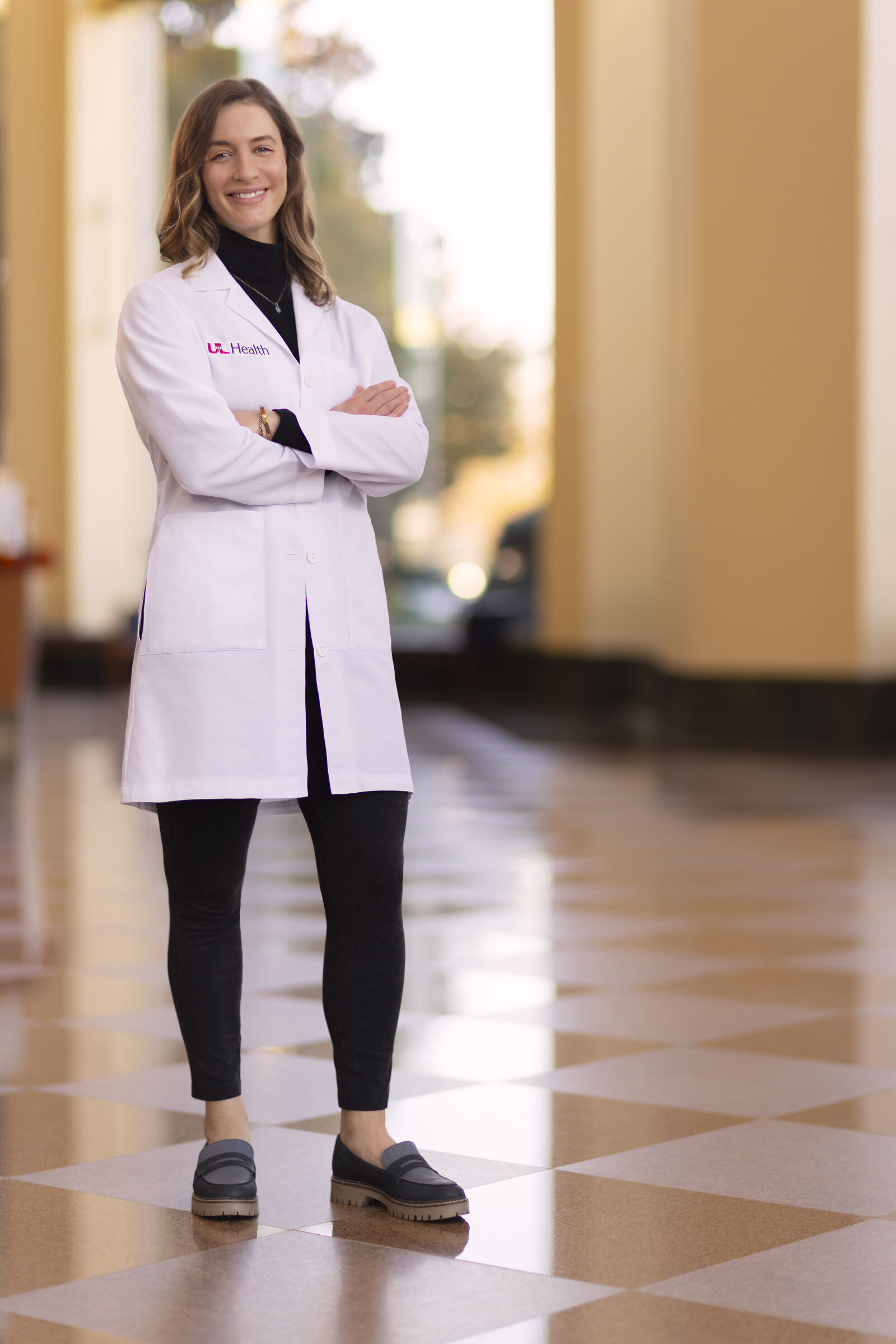 Dr. Elizabeth Bruenderman, bariatric surgeon at UofL Health, standing in the operating room in scrubs