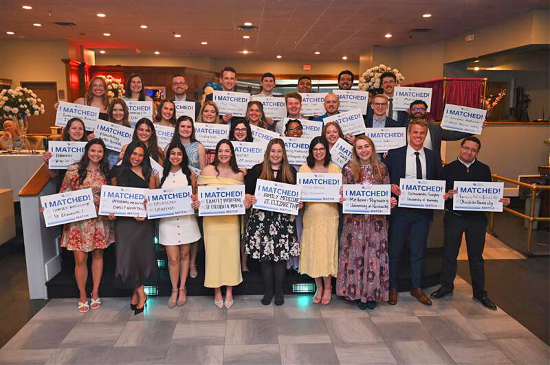 Group photo of the UK College of Medicine Northern Kentucky Campus Class of 2026 holding I Matched signs.