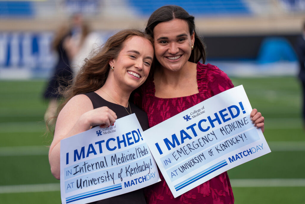 Callie Whitus and Kylie Cochran hold I Matched signs for Internal Medicine/Peds and Emergency Medicine at UK.