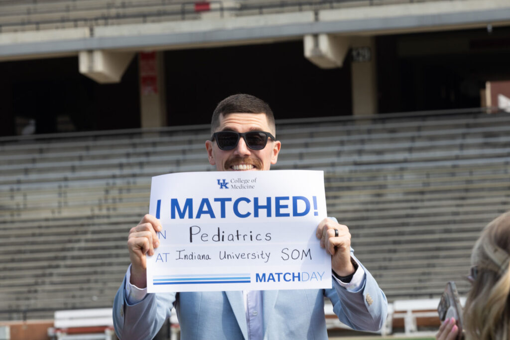 Griffin Green holds an I Matched sign for Pediatrics at Indiana University SOM.