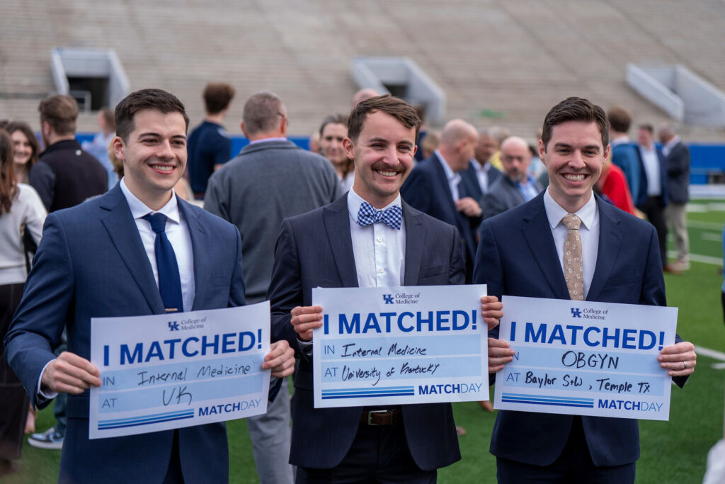 Lucas Maxey, Samuel Golden, and Nathaniel Cox hold I Matched signs.