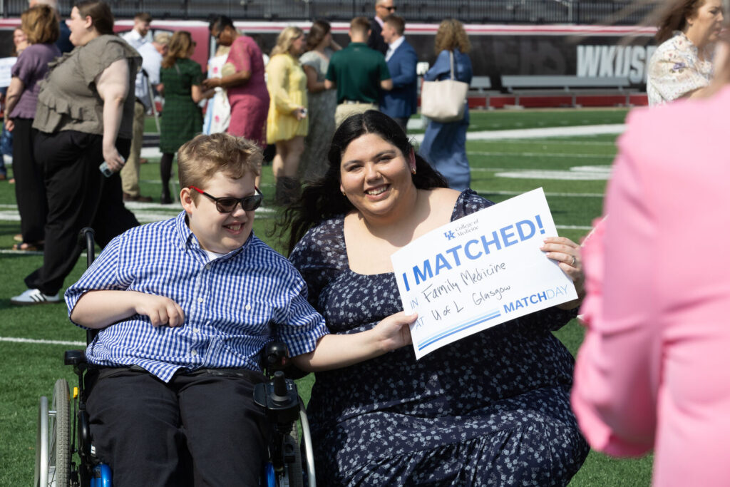 Madeline Blair with her nephew holds an I Matched sign for Family Medicine at UK Glasgow.