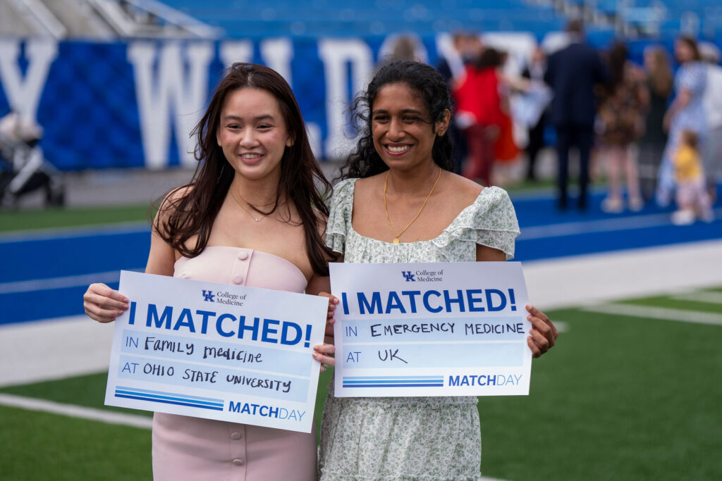 Mindy Baker and Vaaragie Subramaniam hold I Matched signs.