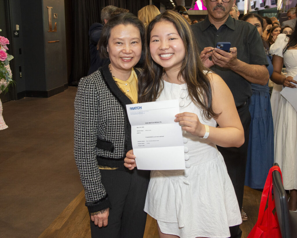 A graduate celebrates her Match Day results with her mother.