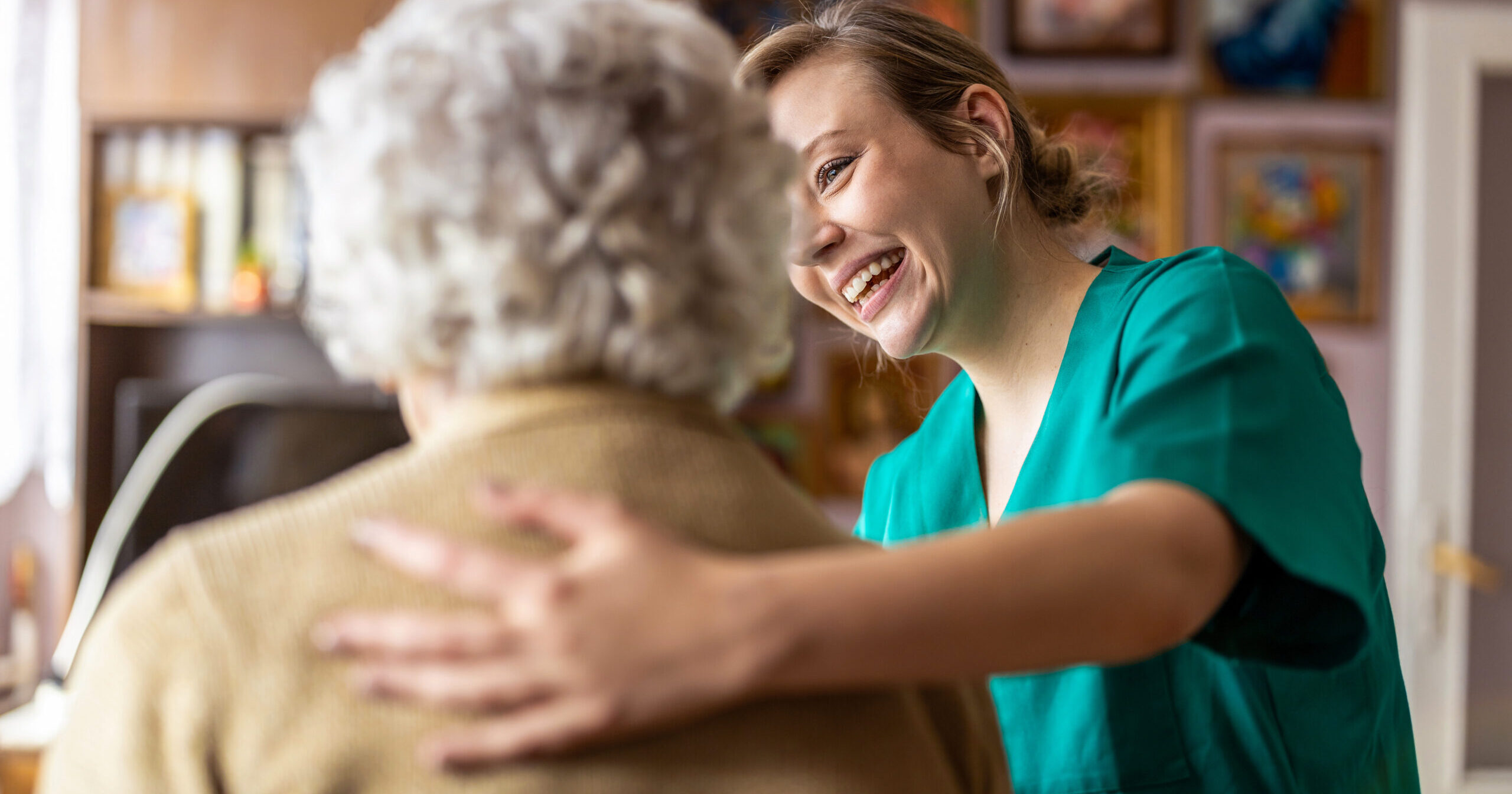 Friendly nurse supporting an elderly lady