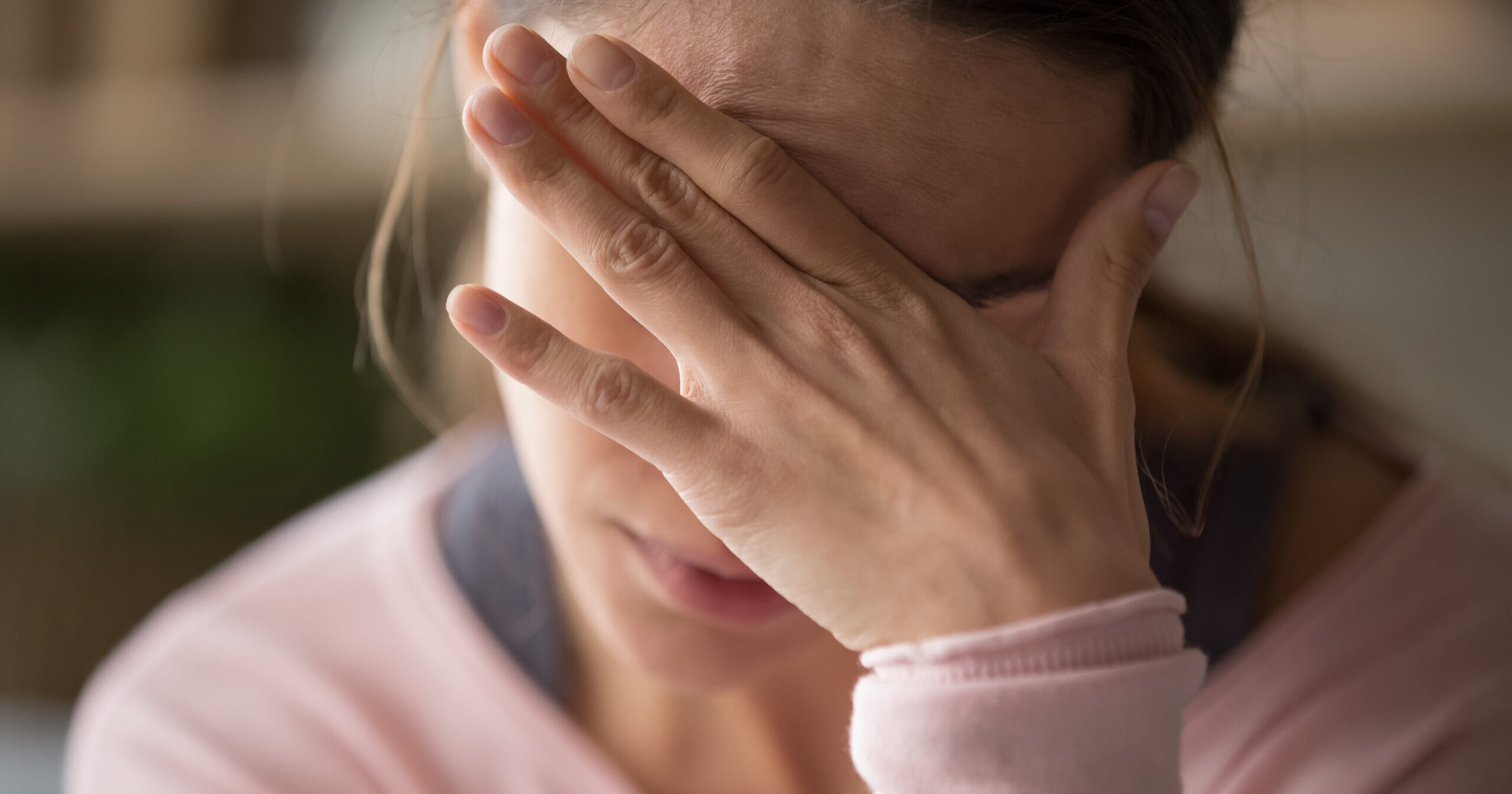 Sad tired woman touching face having headache or depression