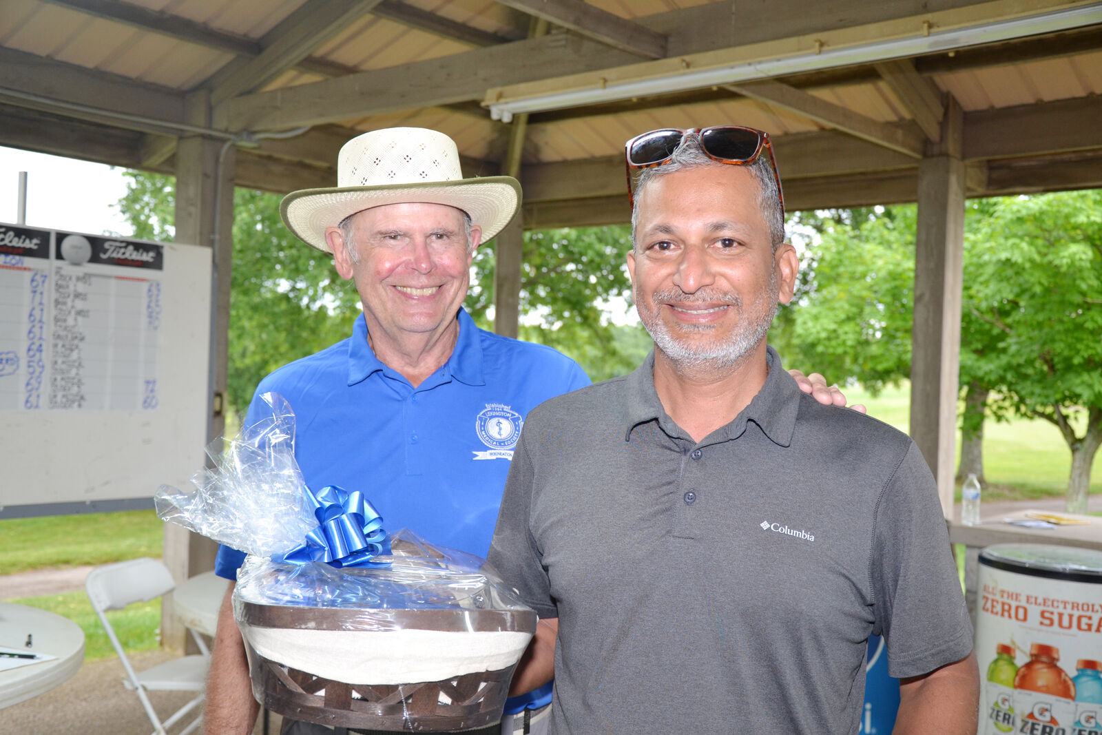 LMSF Golf Tournament chair Dr. Tom Waid congratulates Dr. Ari Padmanabhan for winning first place.