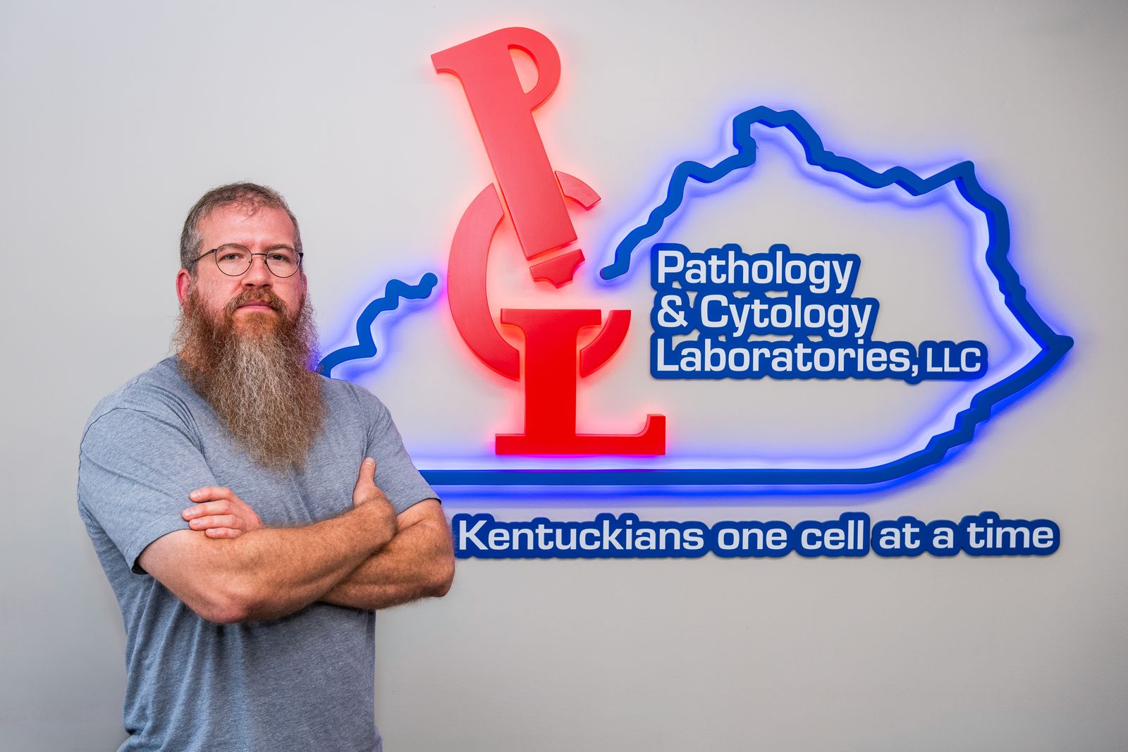 Brad Gibson, MD, in front of the P&C Labs neon sign