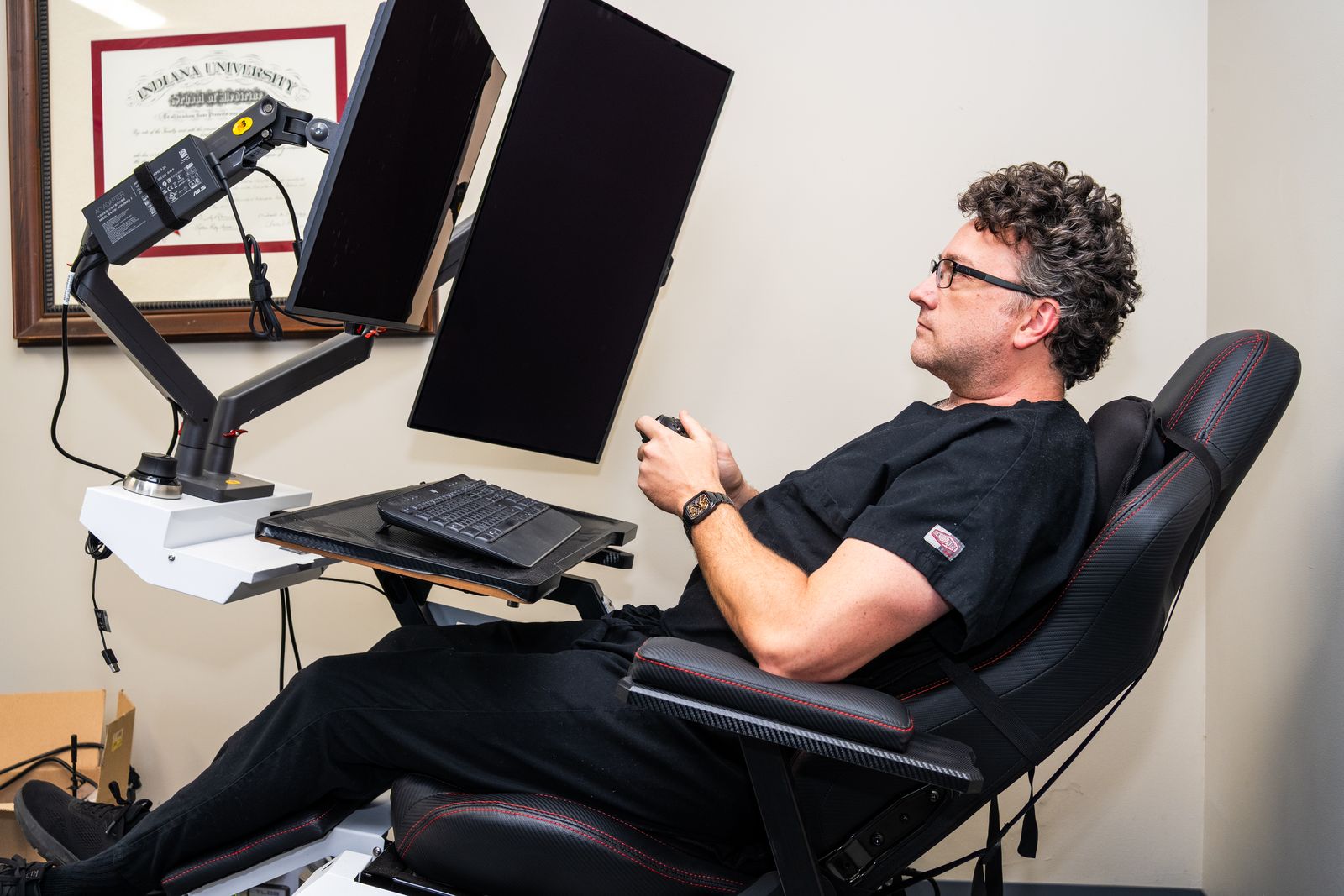 Jason Clark, MD, reviewing slides in a digital reading chair