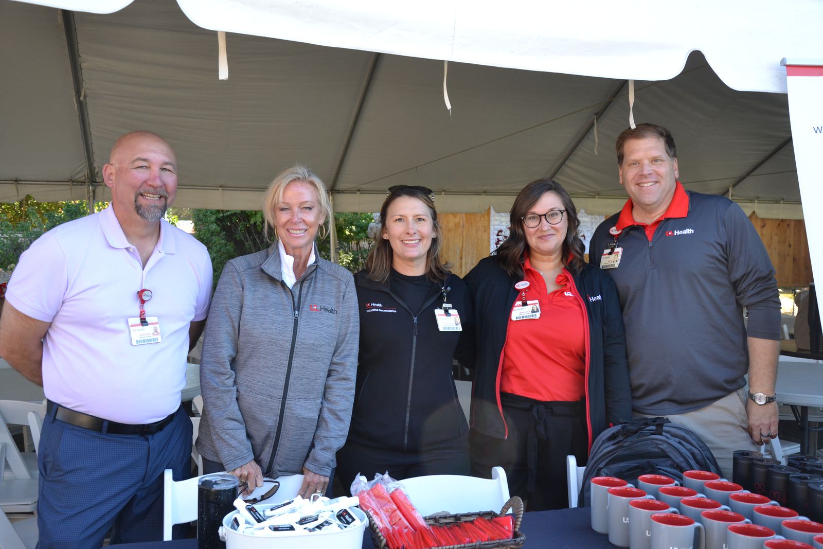 The UofL Health Marketing & Communications team under a tent