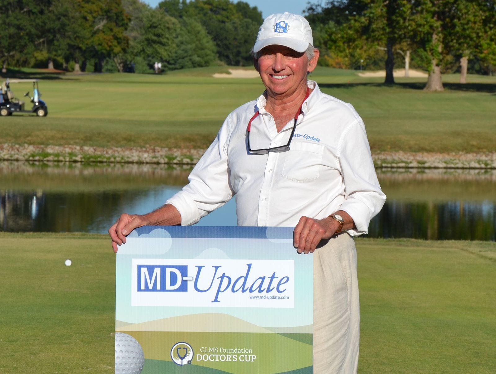 Gil Dunn with the MD-Update hole sponsor sign