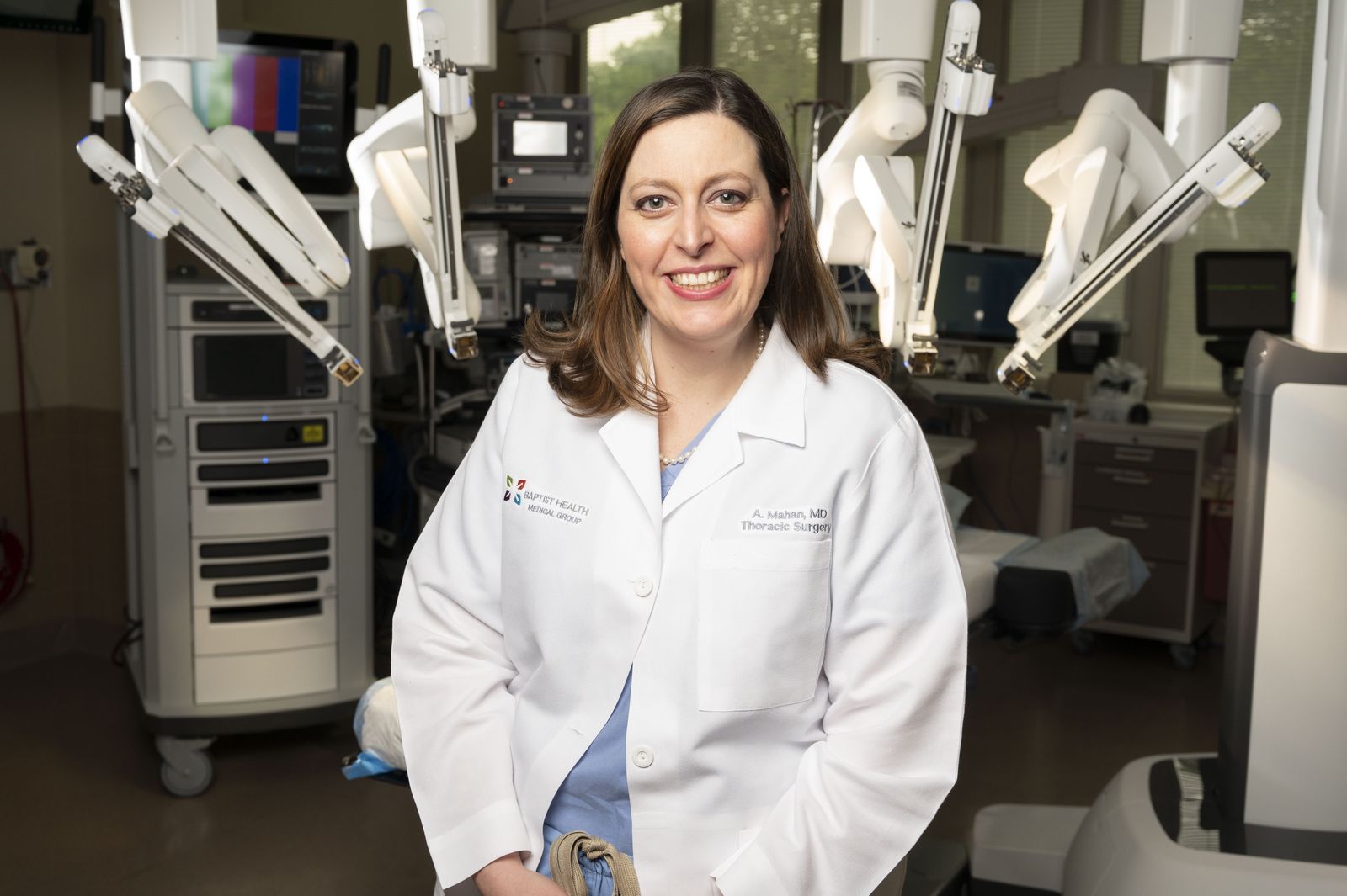 Angela Mahan, MD, beside the Ion robotic system