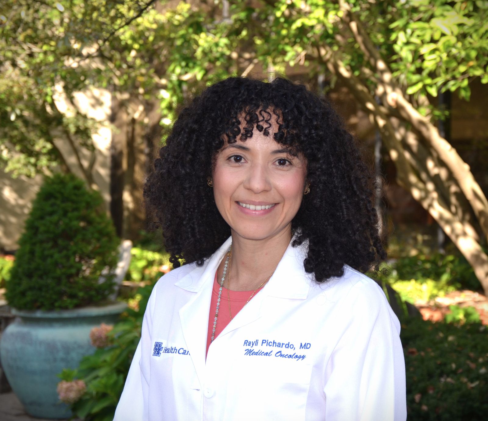 Rayli Pichardo, MD, in a white coat outdoors