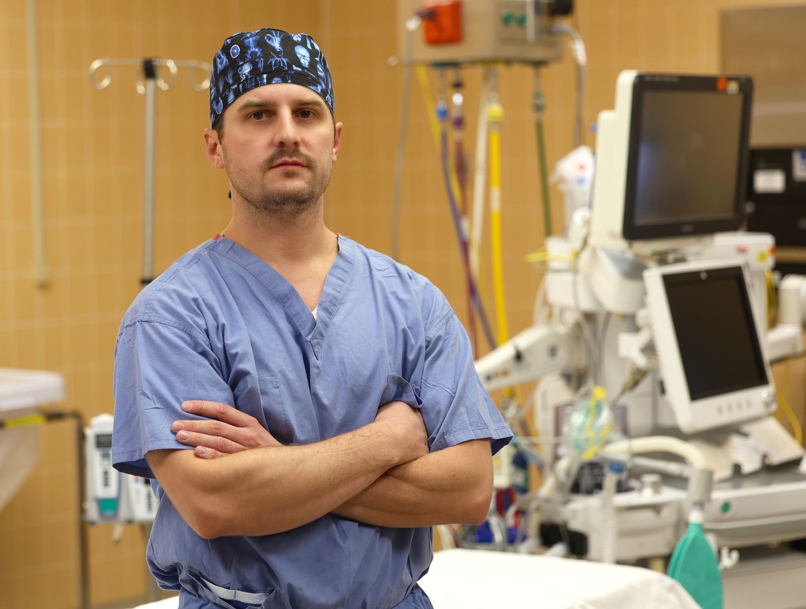 Joshua David Harman in scrubs and a surgical cap